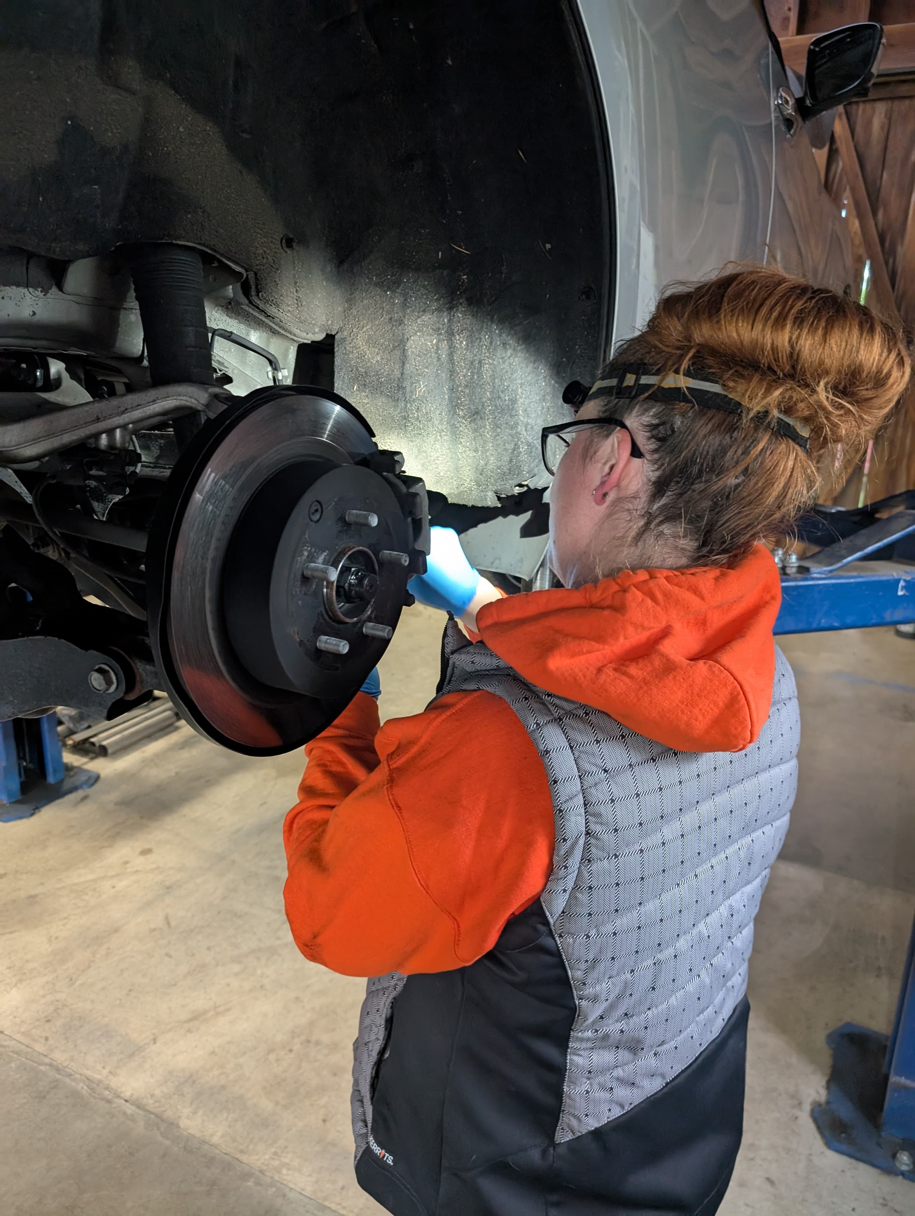 Inspecting brake rotor and hub assembly on the lift