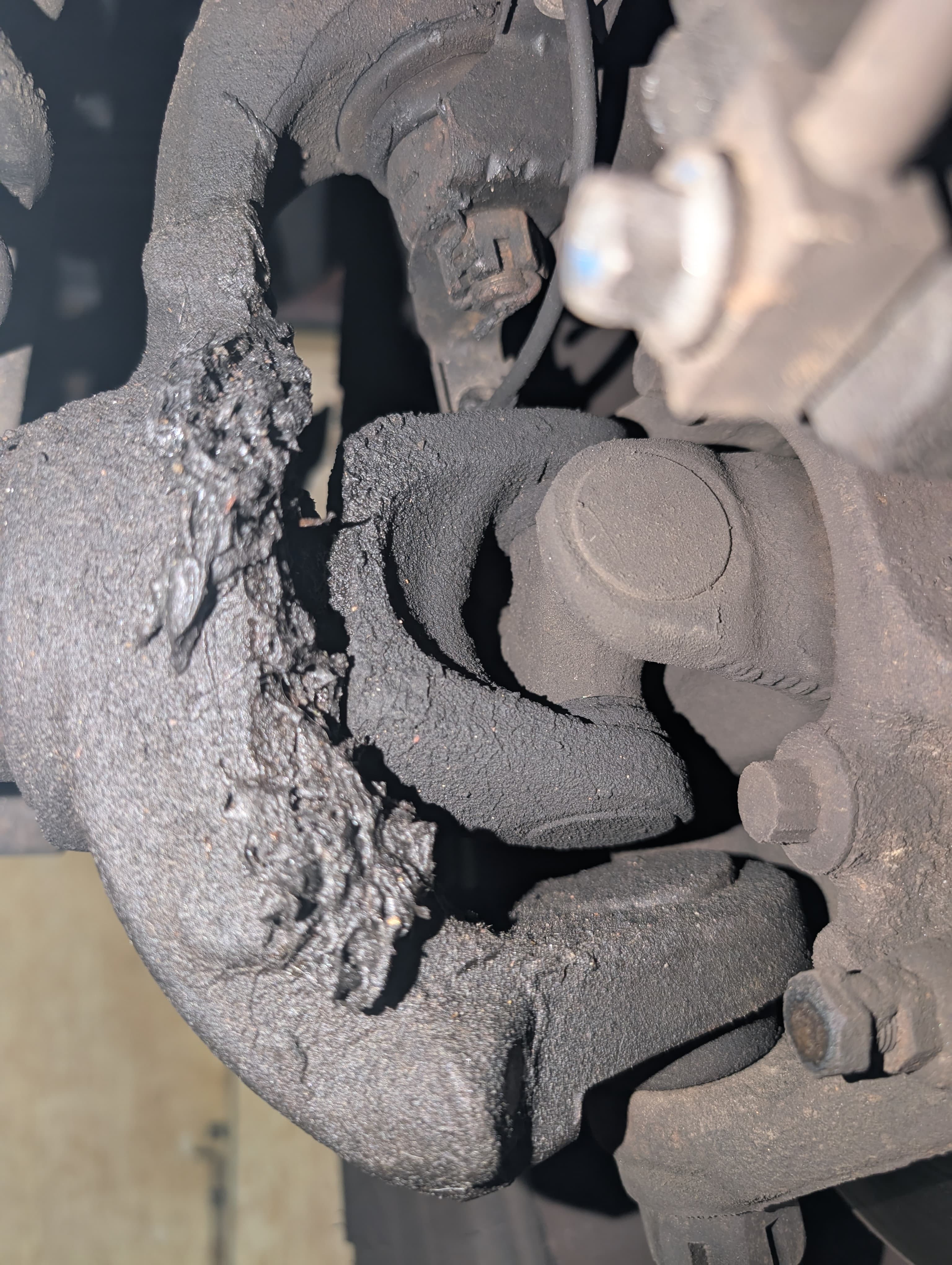 Heavily worn brake caliper with dust buildup